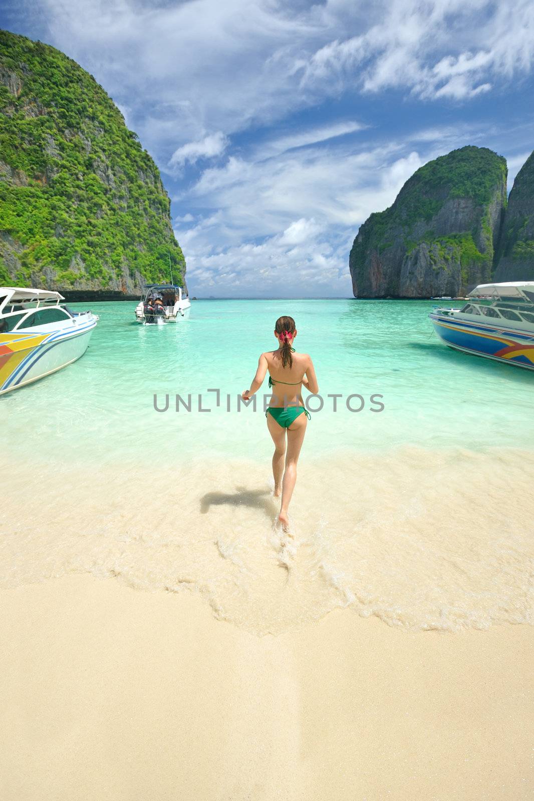 Woman running in water in beautiful lagoon at  Phi Phi Ley island, the exact place where "The Beach" movie was filmed