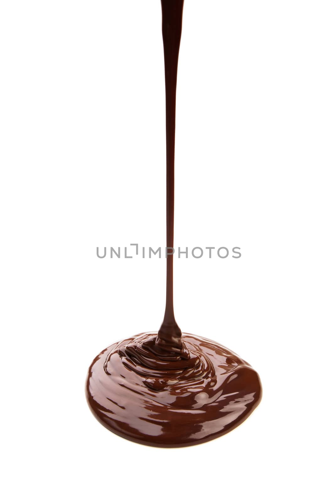 Melted chocolate flowing on chocolate plates isolated on white background