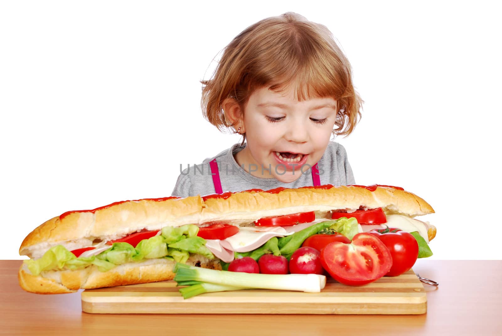 hungry little girl tries to eat big sandwich