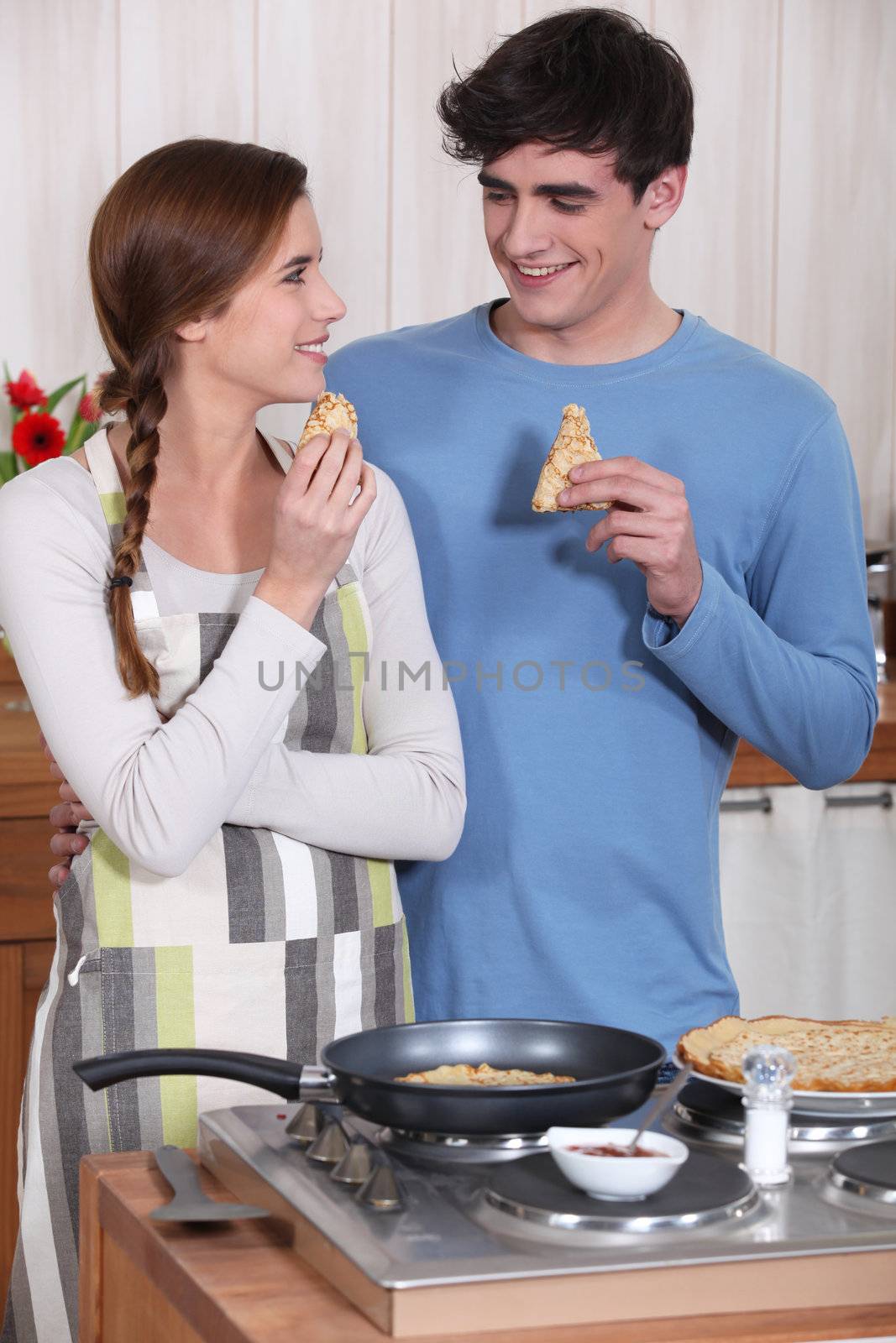 Couple eating pancakes by phovoir