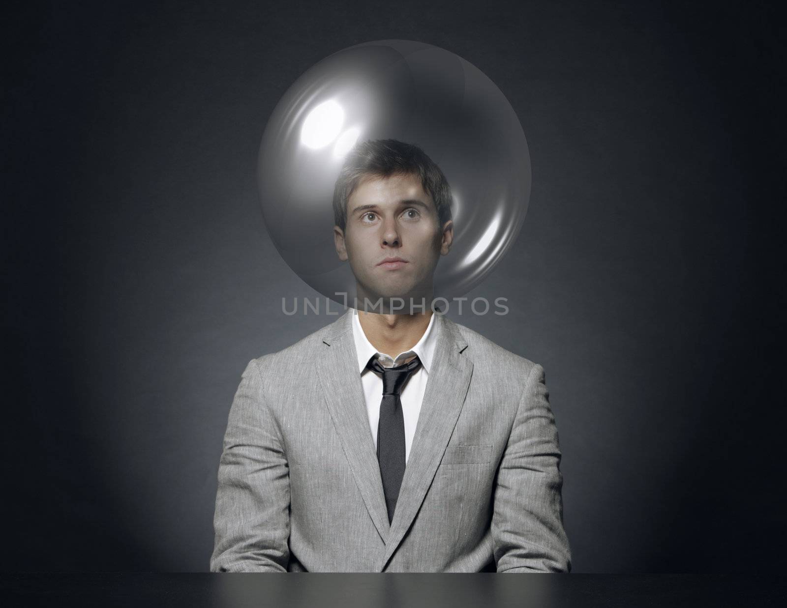 young businessman with head in a transparent bubble