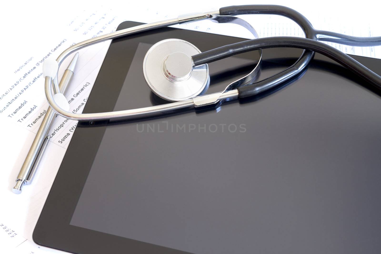 Digital tablet with stethoscope and paperwork