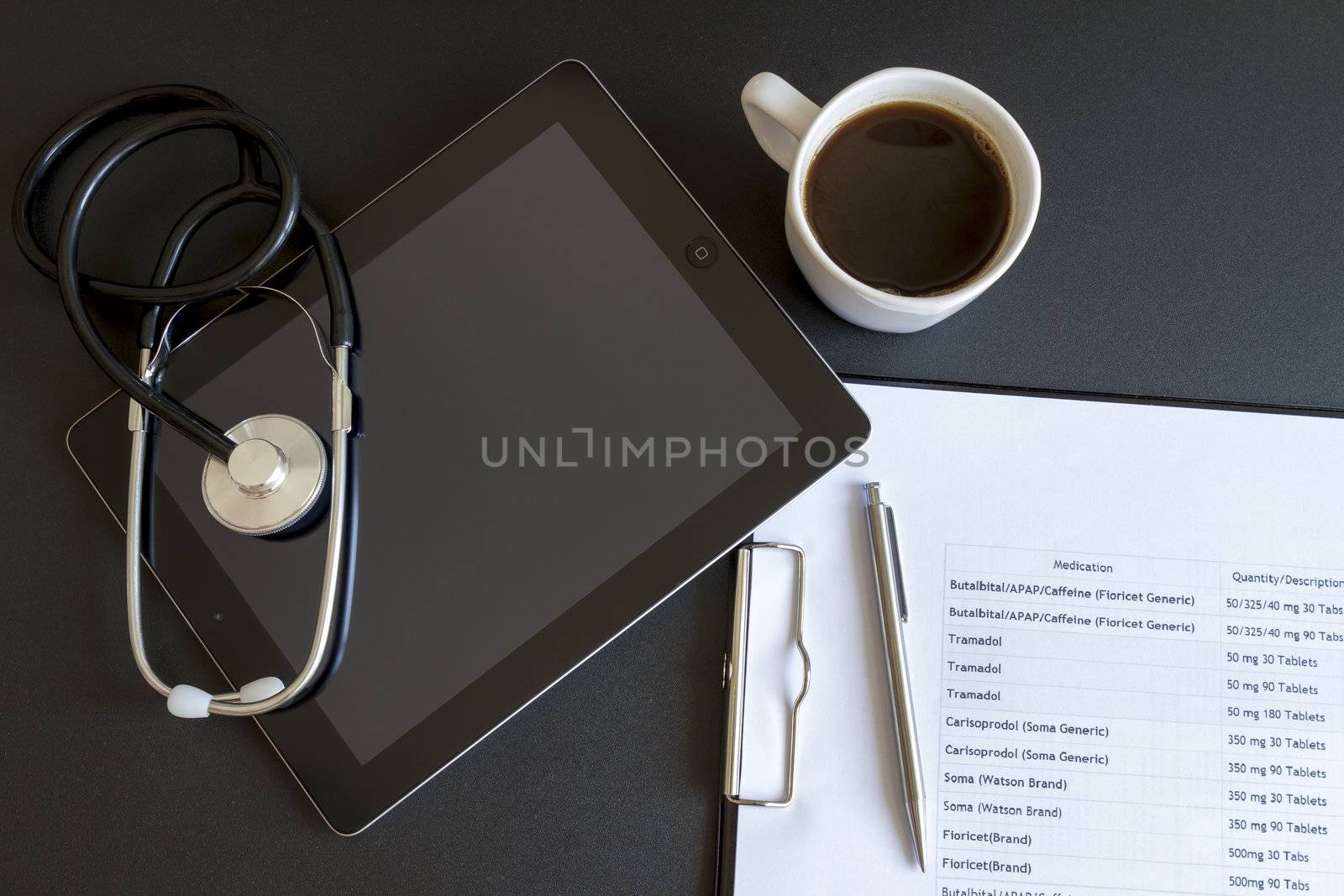 Digital tablet with stethoscope and paperwork