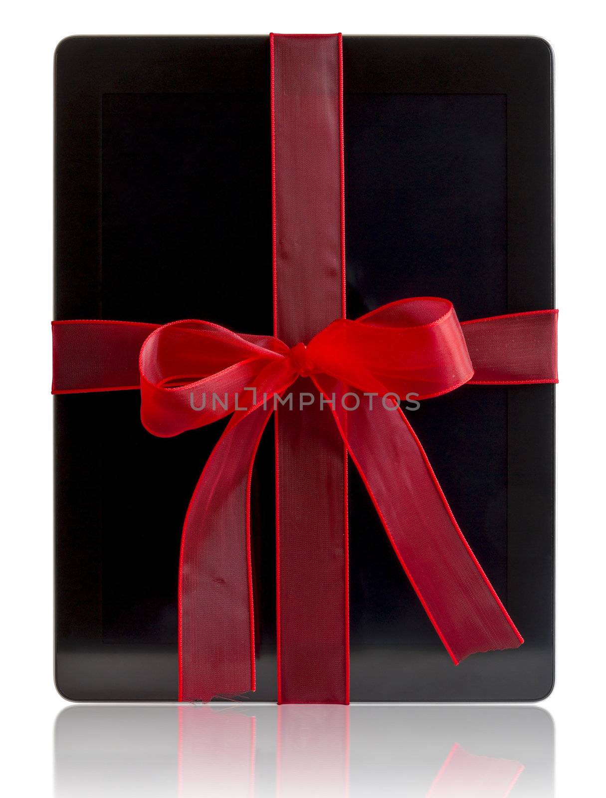 Digital tablet with red ribbon gift isolated on white.