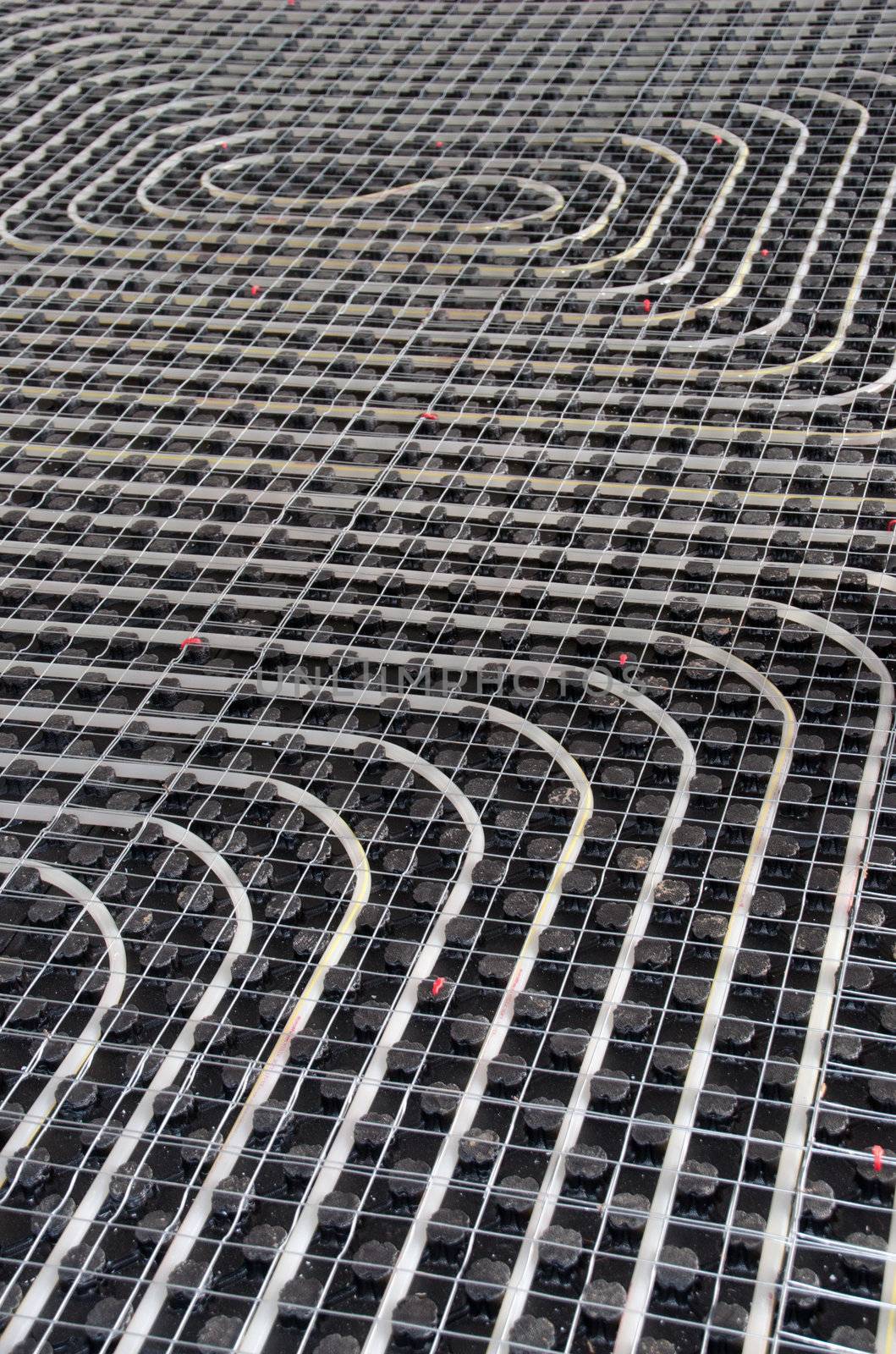 Black underfloor heating posed in a underconstruction building