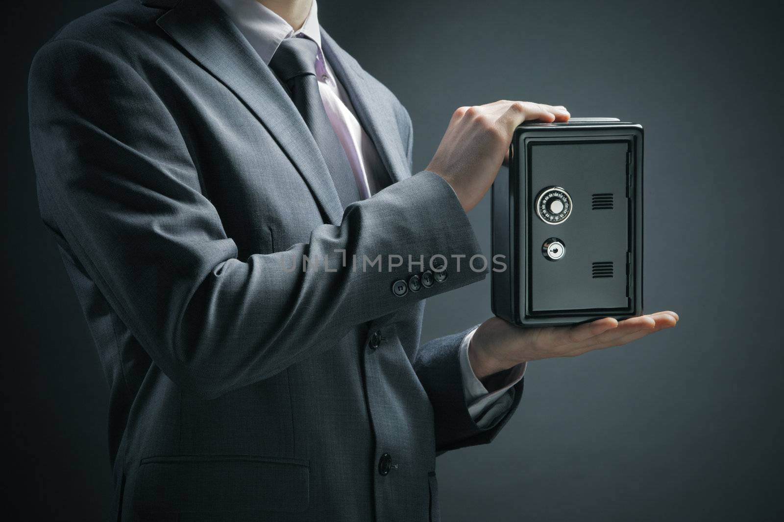 Businessman protecting his savings in the safe