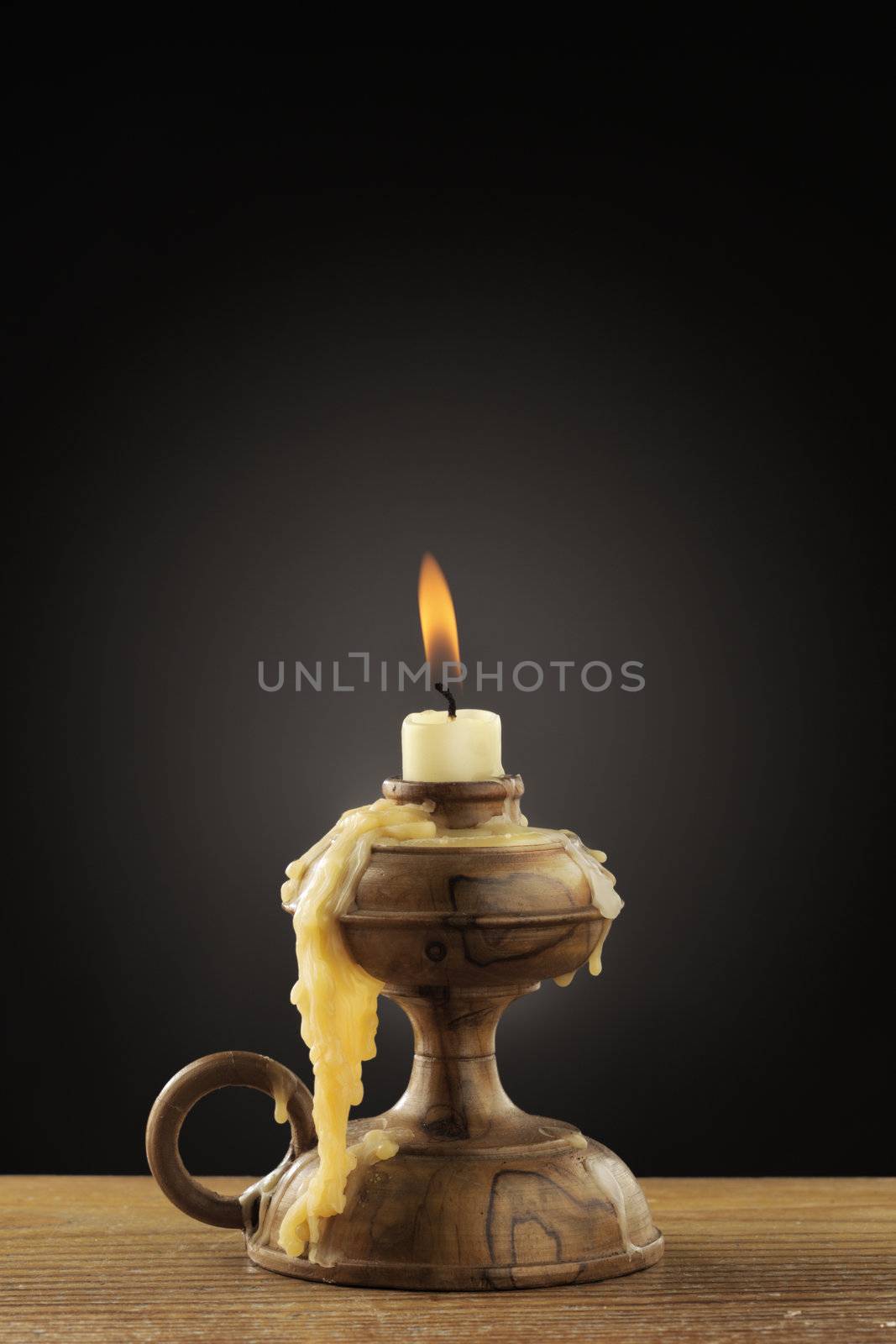 Old candle on dark background