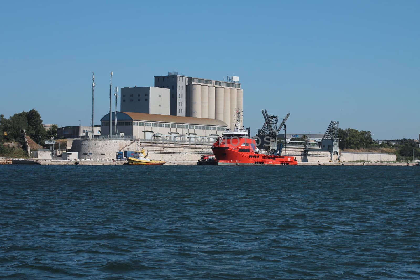 Port of Brindisi with boats and a tugboat
