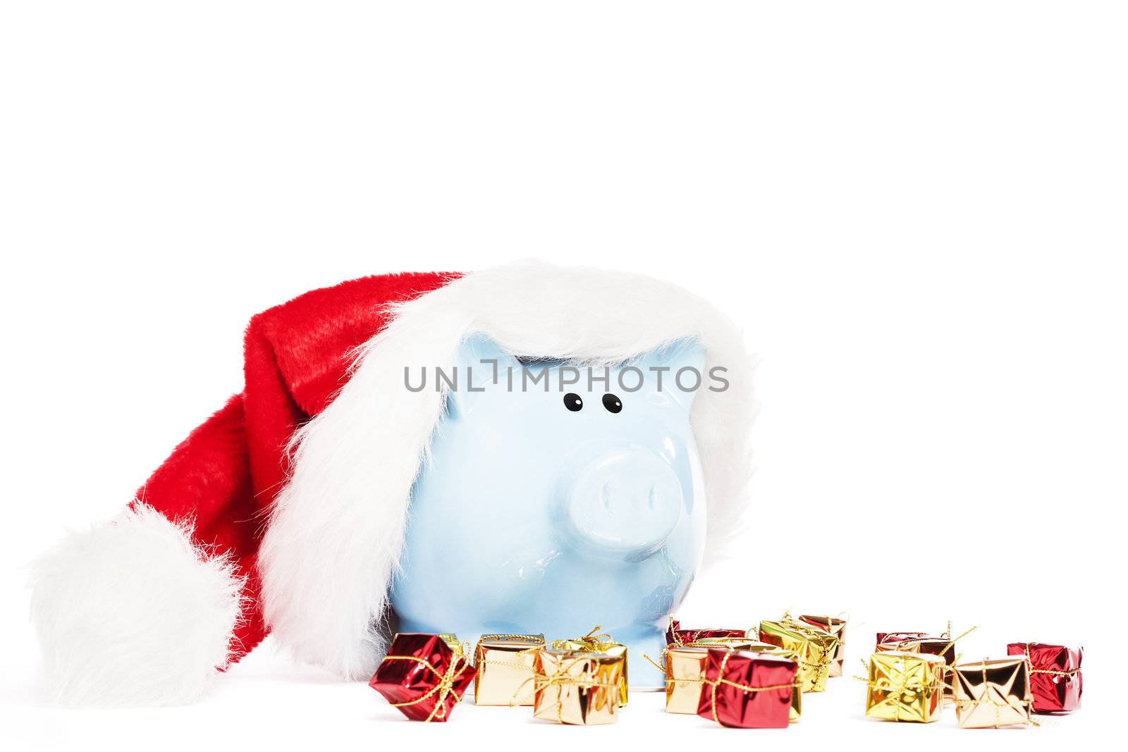 piggy bank wearing santas hat with tiny christmas presents on white background