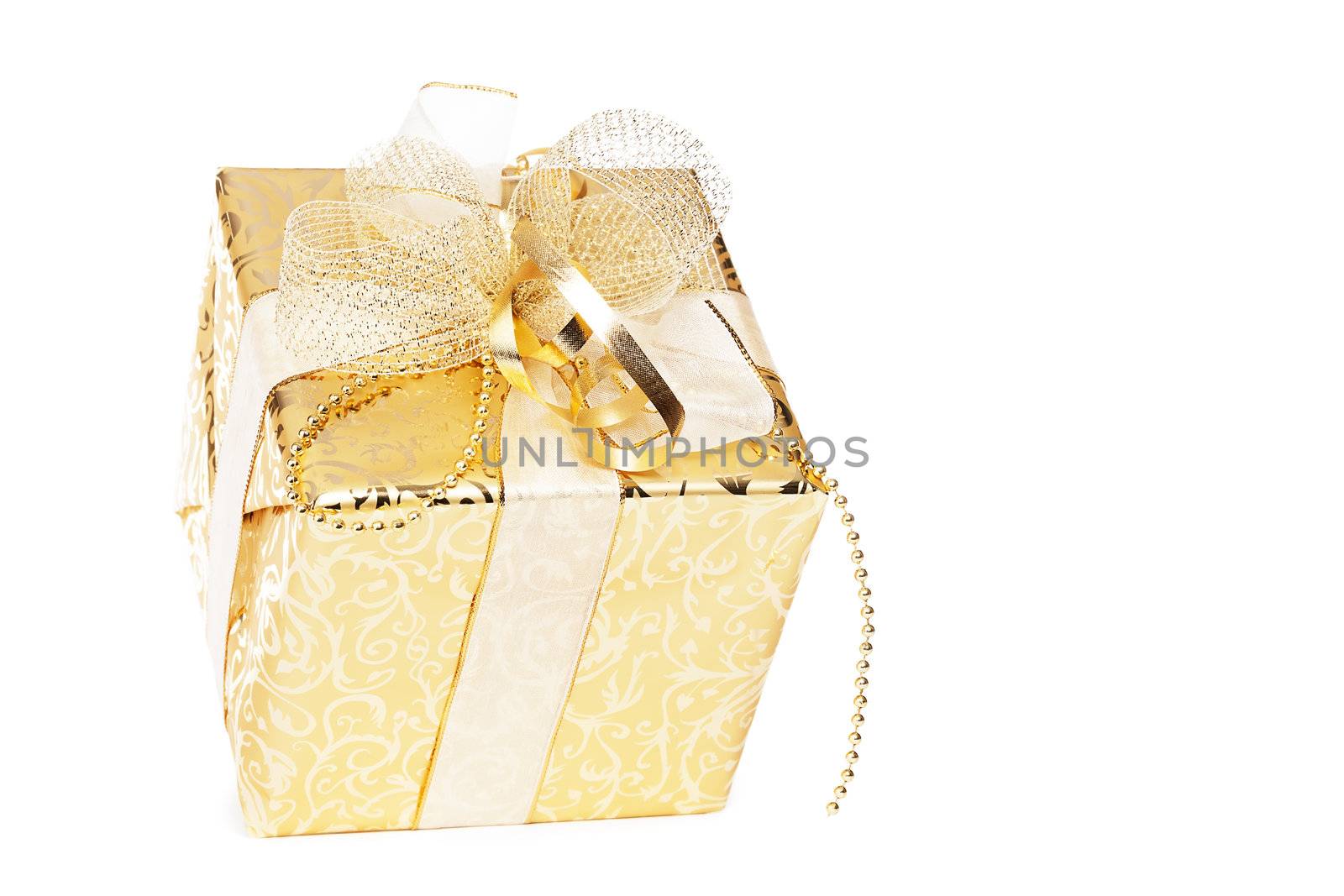 golden christmas present with golden ribbons on white background