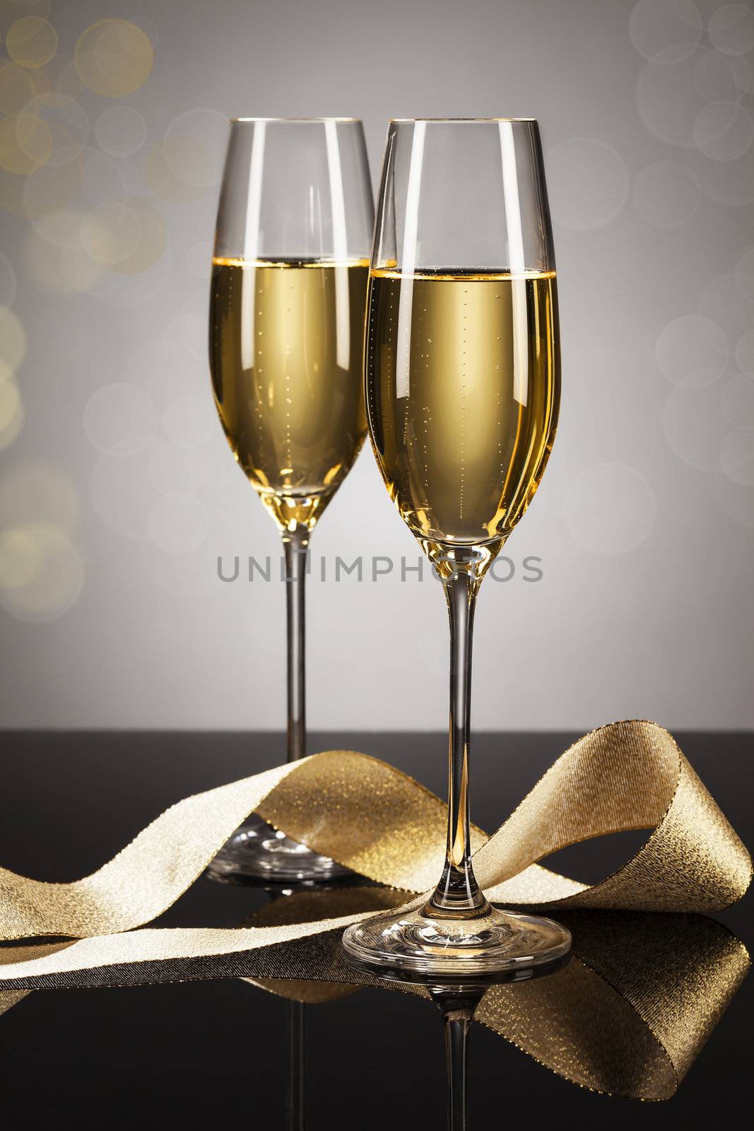 two glasses of champagne with a golden ribbon by RobStark