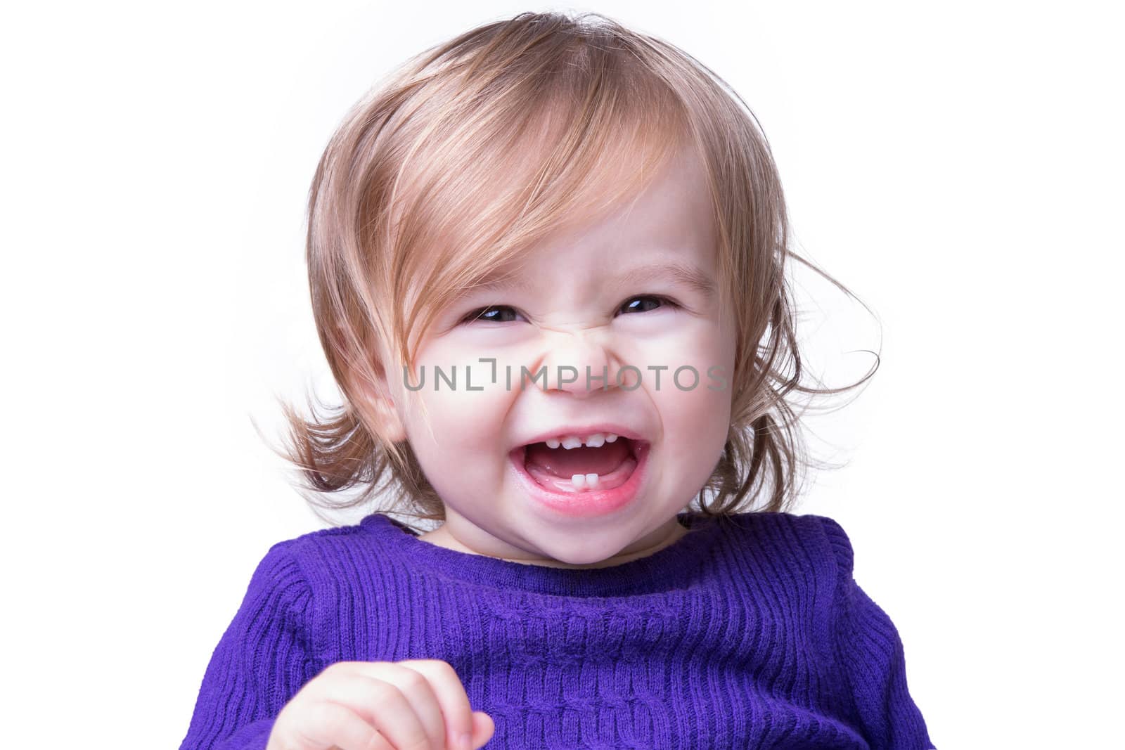 Happy baby is laughing fearless and freely with her new teeths, looking in to camera. Isolated on white.