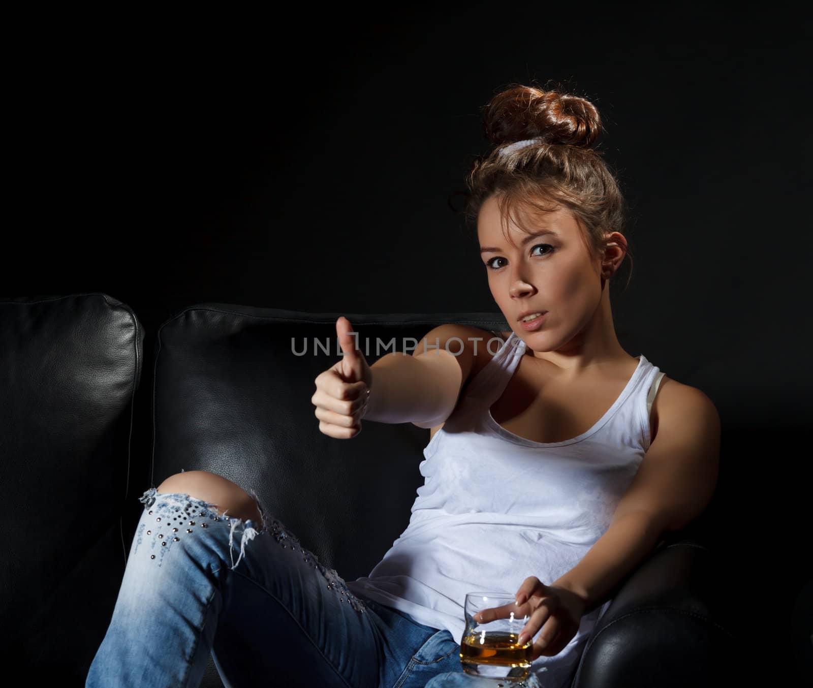 Portrait of a woman with a glass of alcohol, dark background