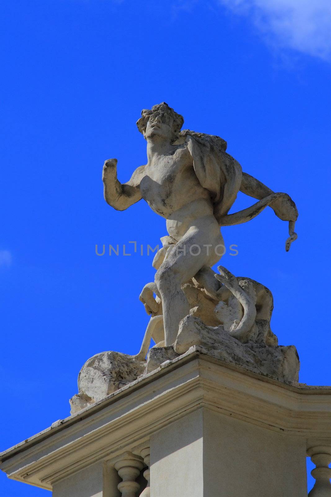 Statue of man with snake in Rome Italy, Villa Borghese