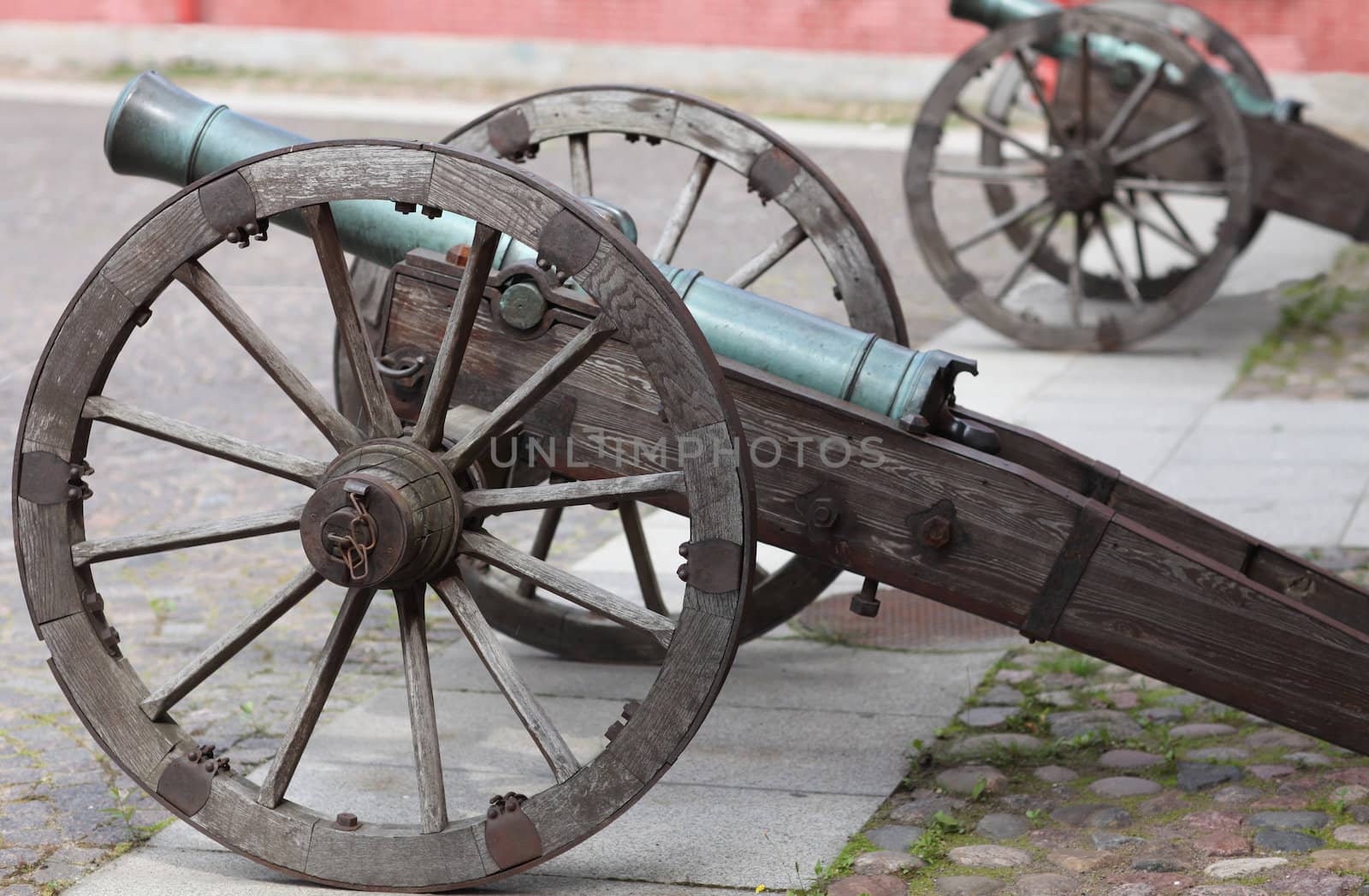 The old medieval bronze cannon on the gun carriage