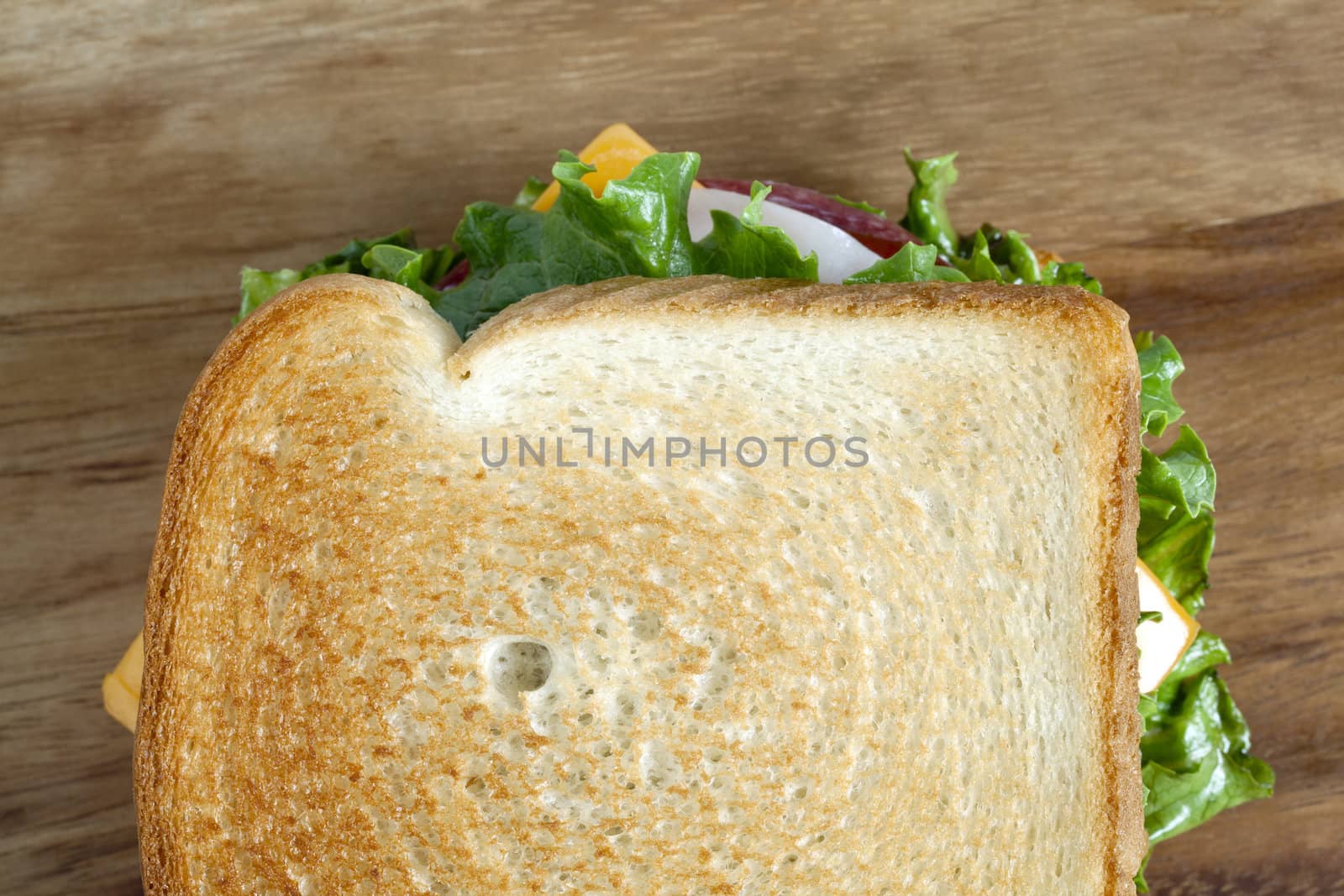 Horizontal image of a delicious ham sandwich over a wooden background