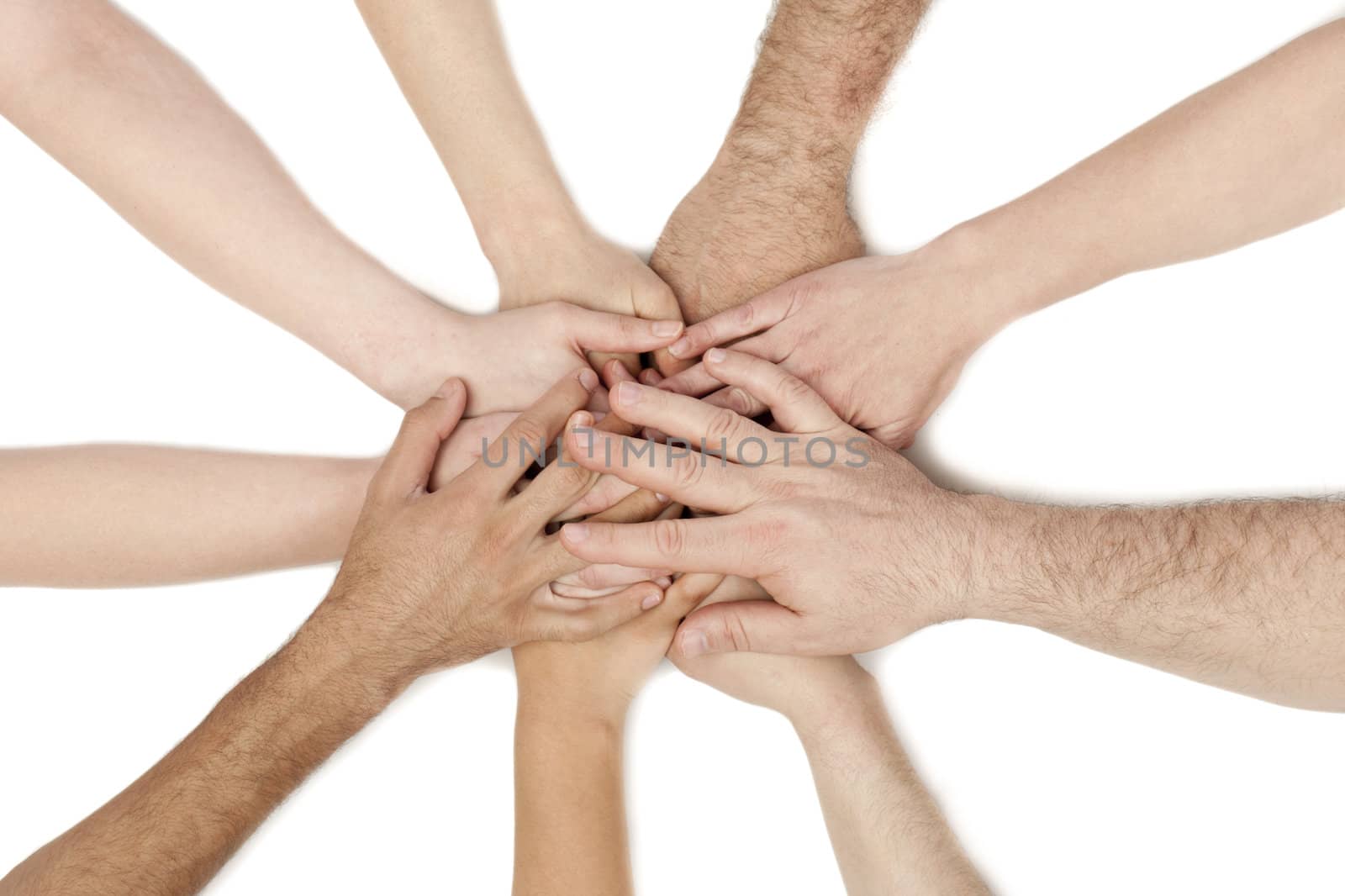 A diverse group of business workers with their hands together in form of teamwork and unity