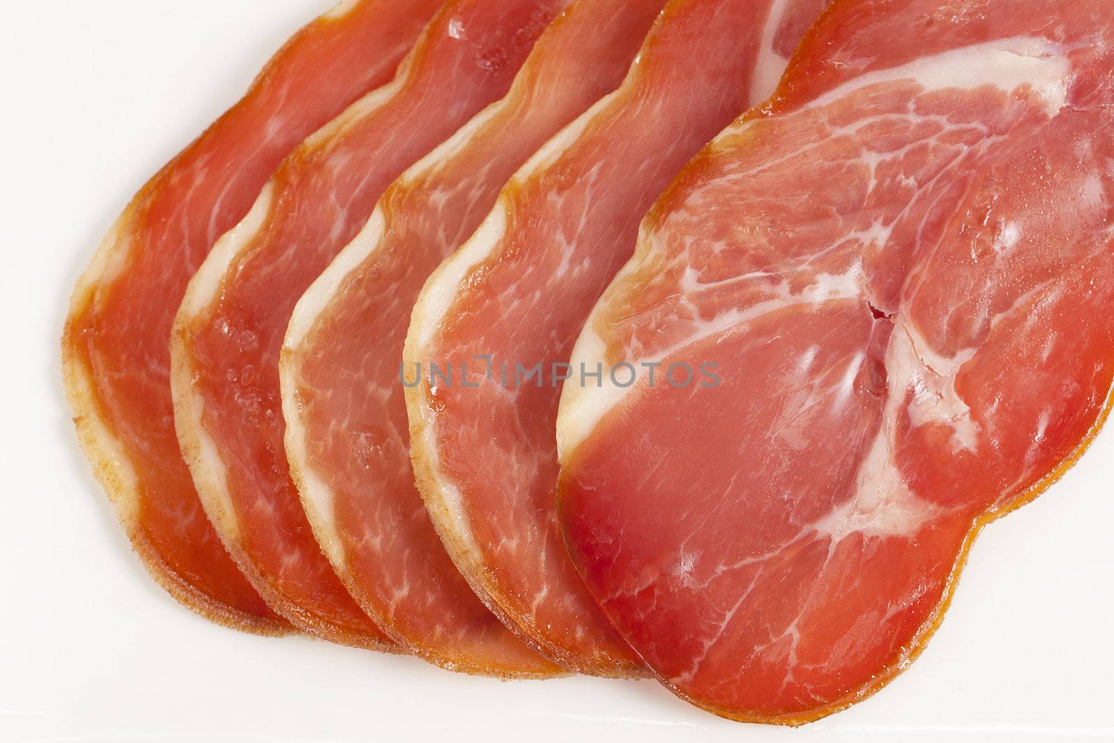 Macro shot in the fresh cut of ham against a white background