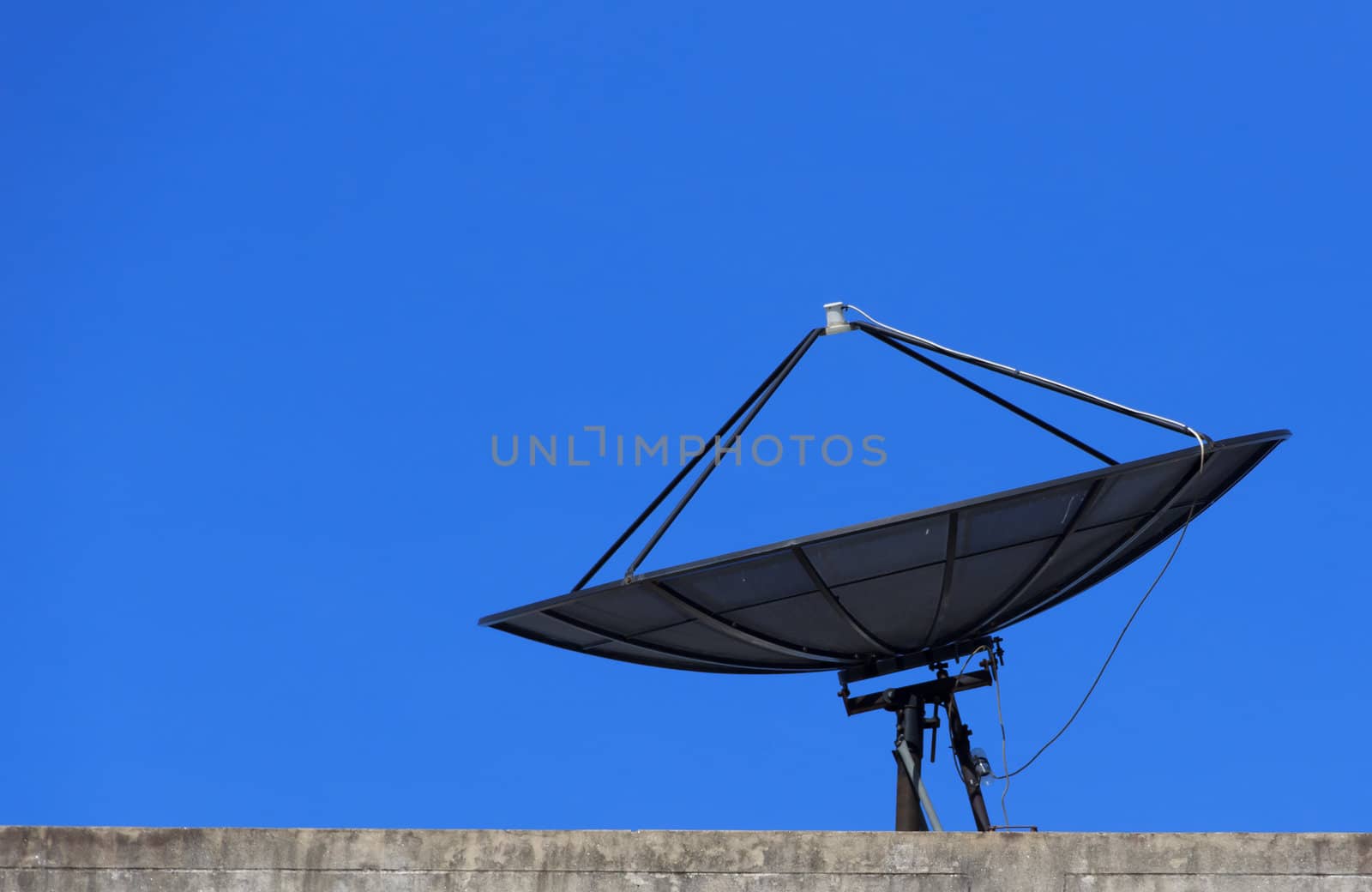 Satellite dish with blue sky on roof, Closeup