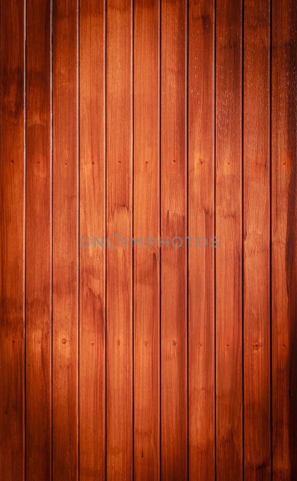 Wood texture background in vertical pattern, dark brown color.