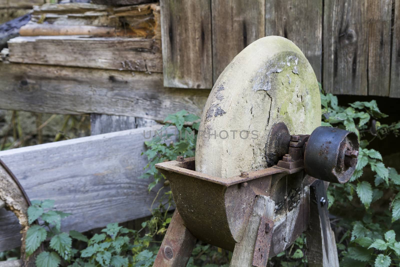 old, used grinding stone in romantic background