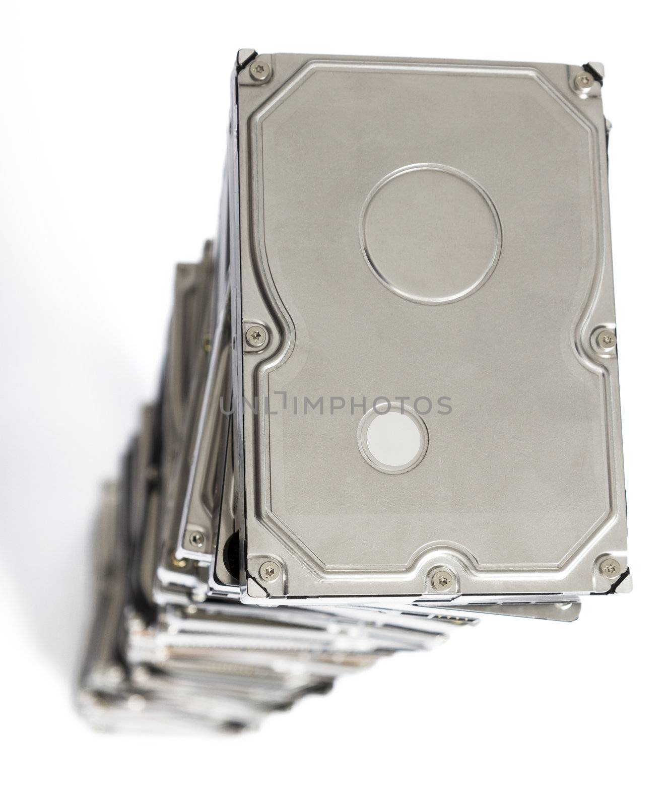 high stack of used hard drives by gewoldi