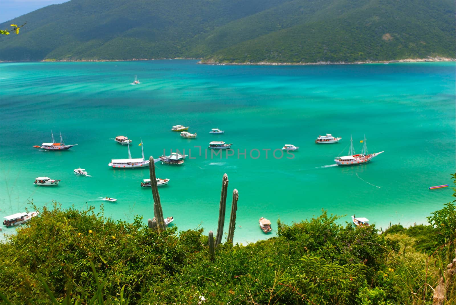 Boats over a crystalline turquoise sea in Arraial do Cabo, Rio de janeiro, Brazil