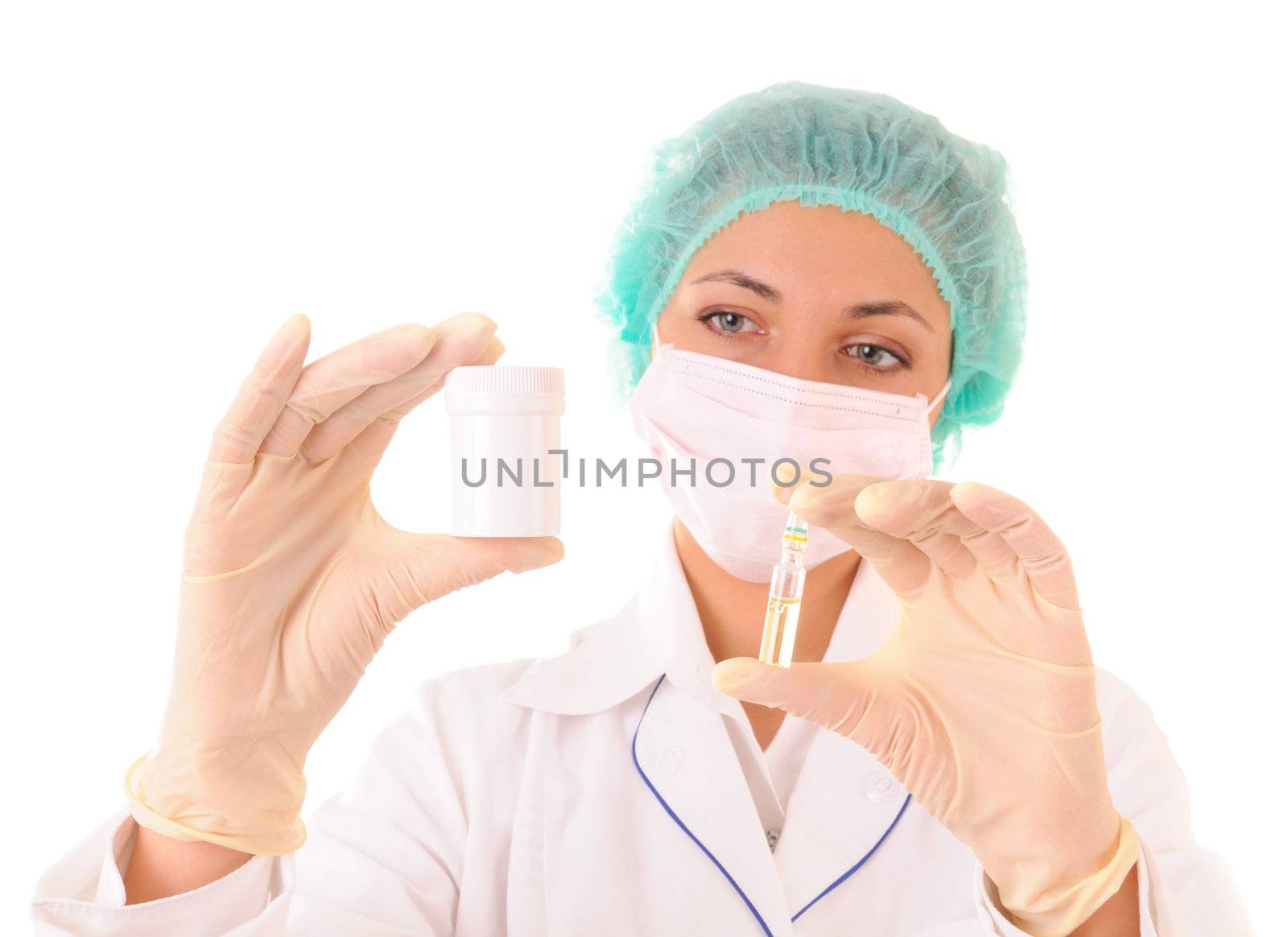 Woman in medical workwear with bottle and ampule with medicines in hands. Isolated on white background. Focus on hands.