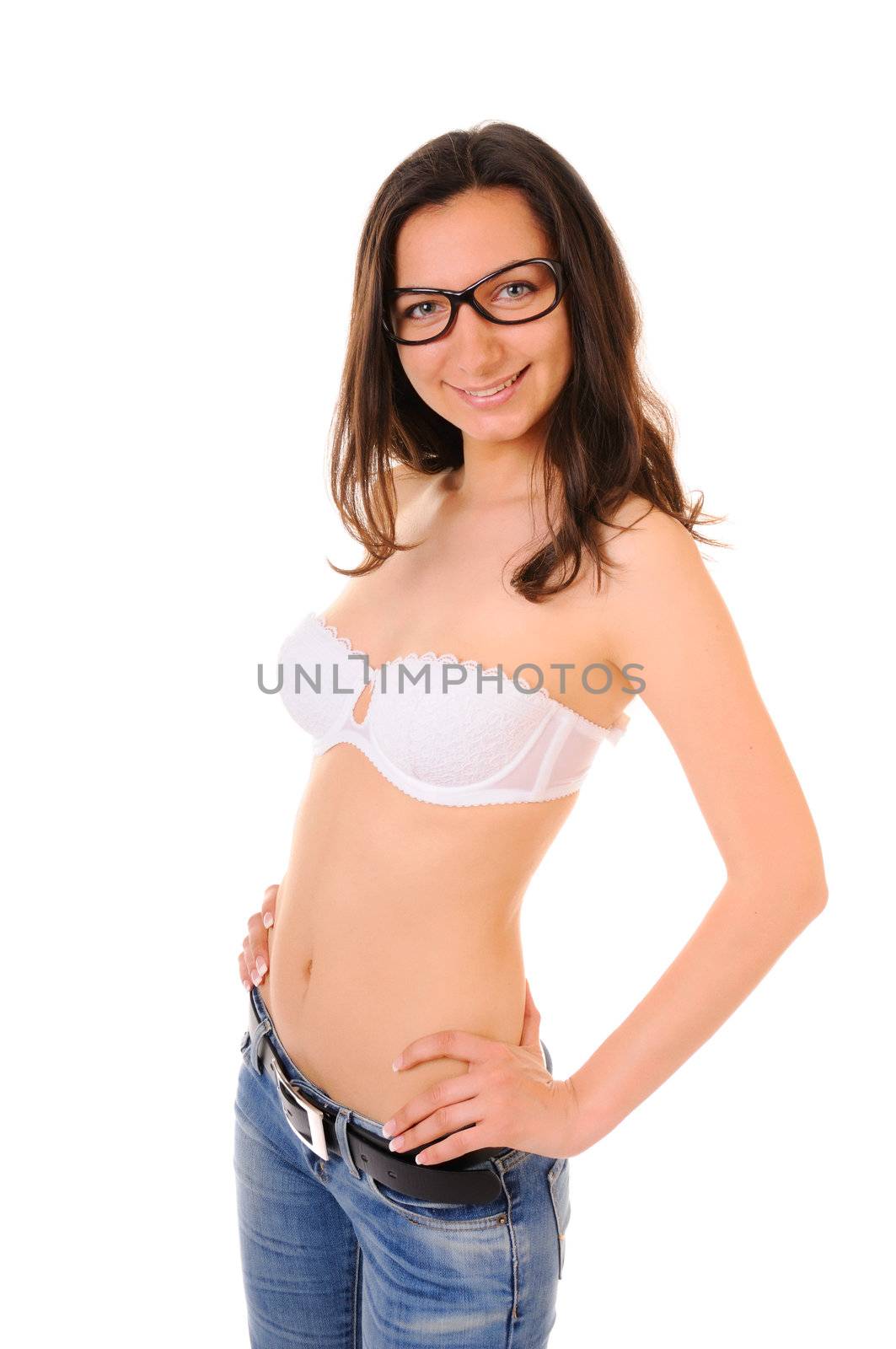 Smiling young woman in bra and jeans isolated on white background.