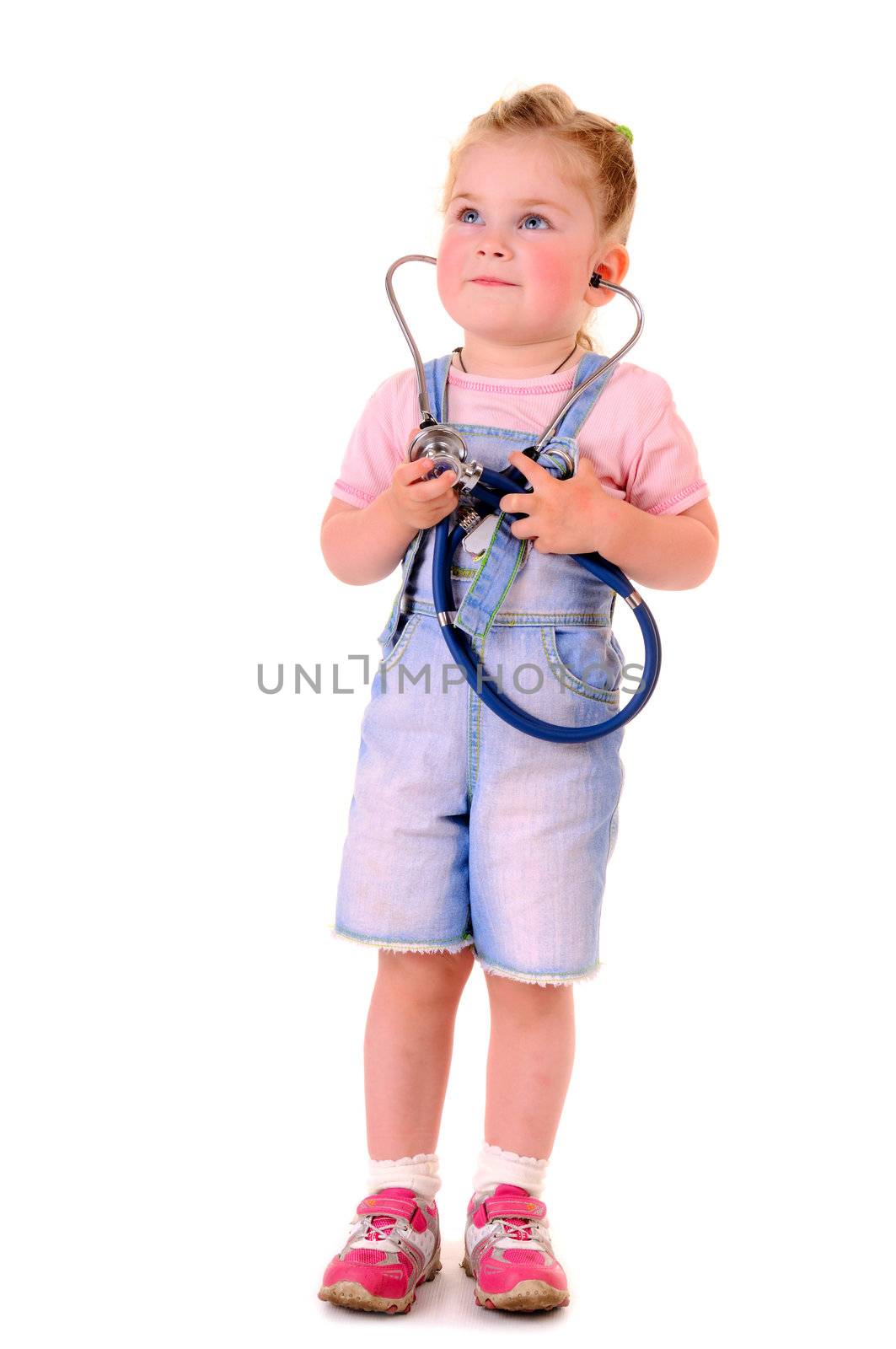 Small playful girl with stethoscope on white background