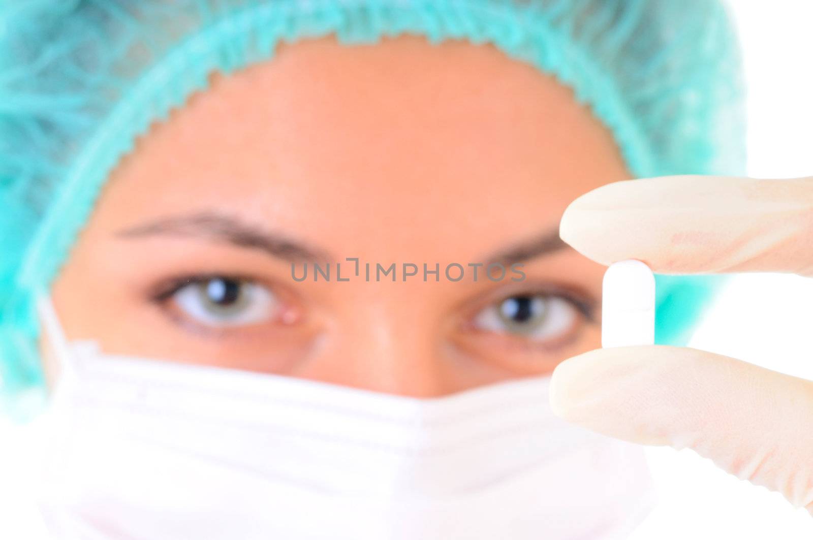 Close-up of a tablet in doctor's hands in gloves with female face out of focus on background