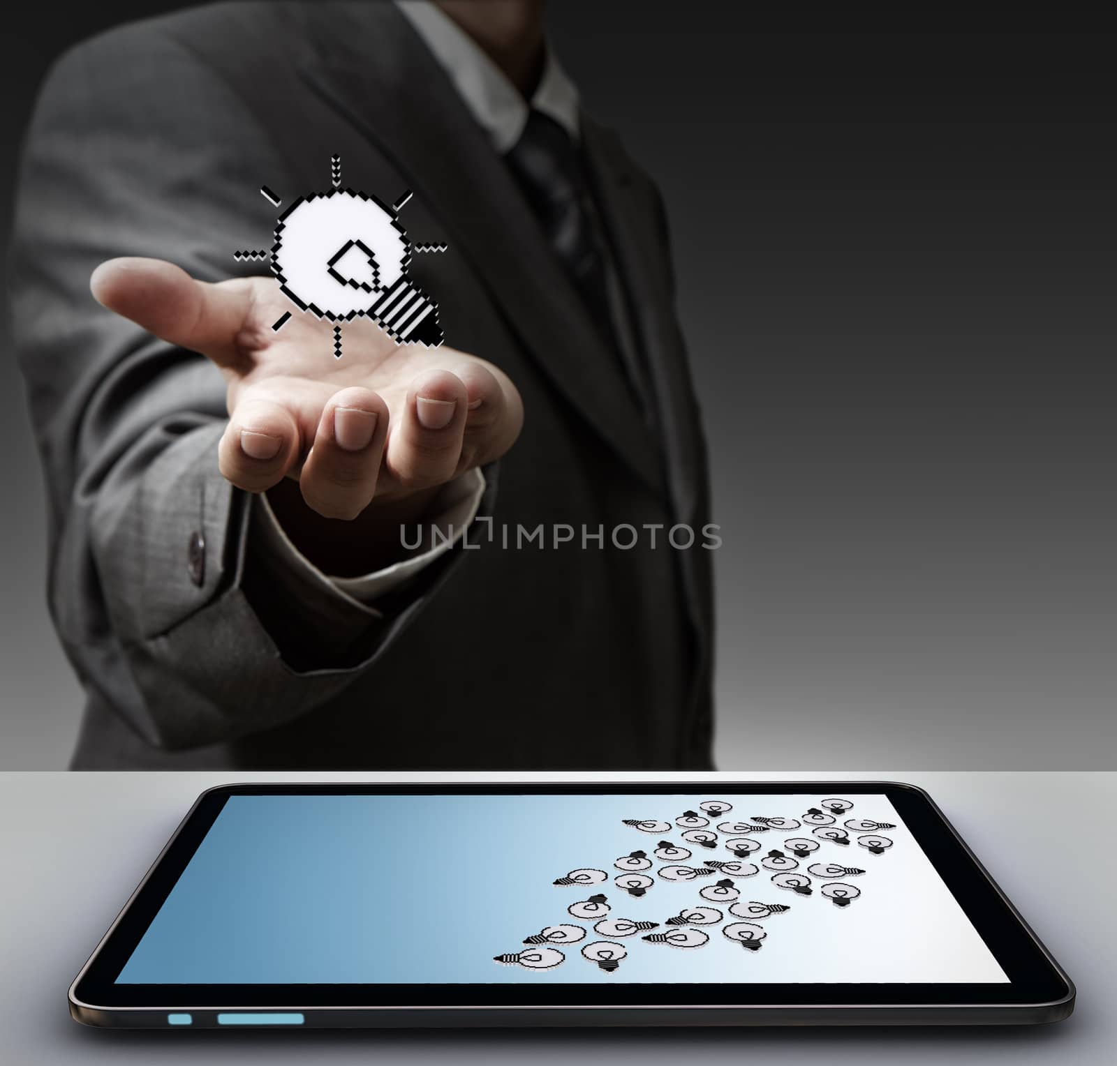 business man hand shows pixel light bulb icon and tablet computer as concept