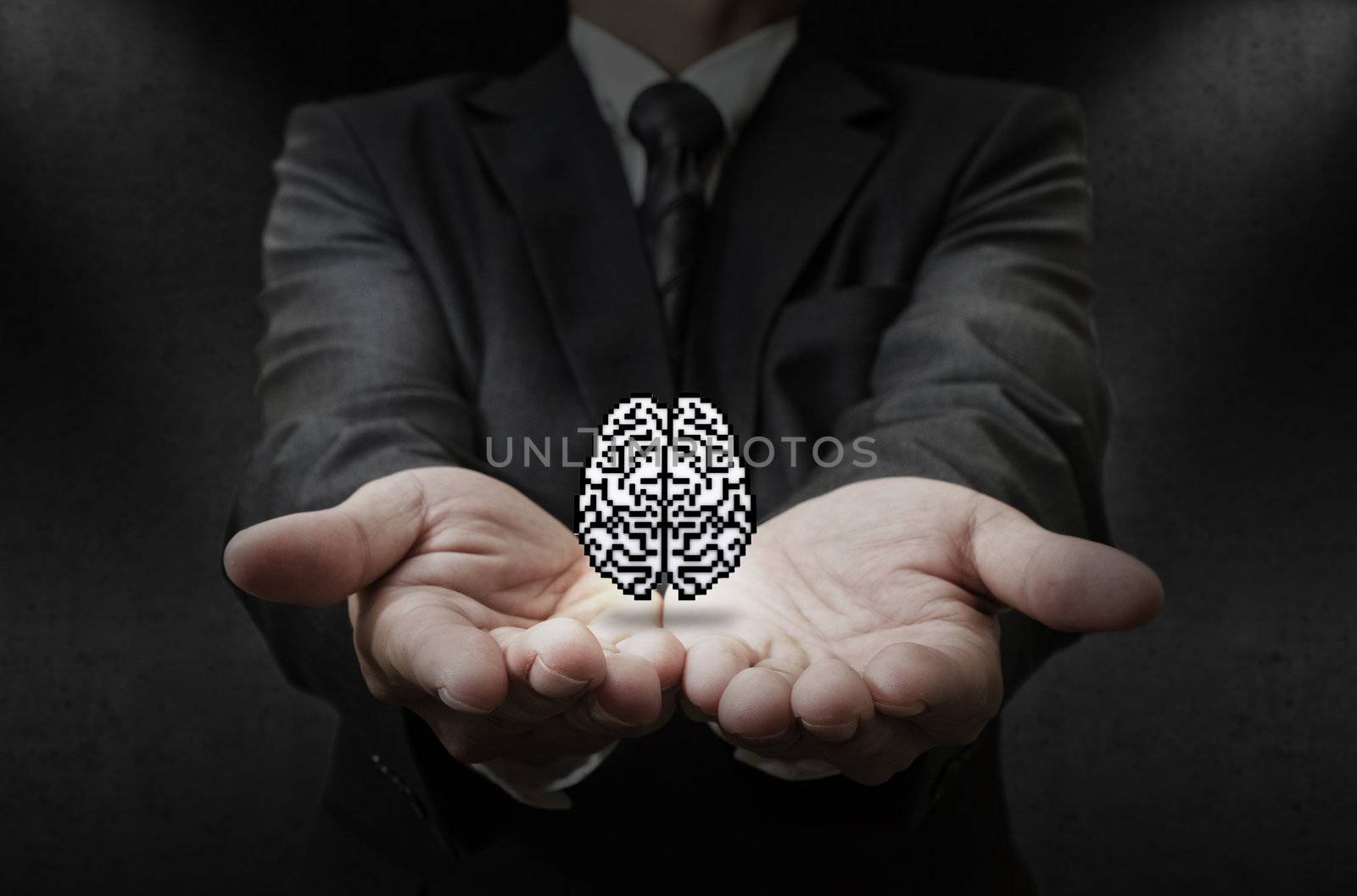 business man hand shows pixel brain icon as concept