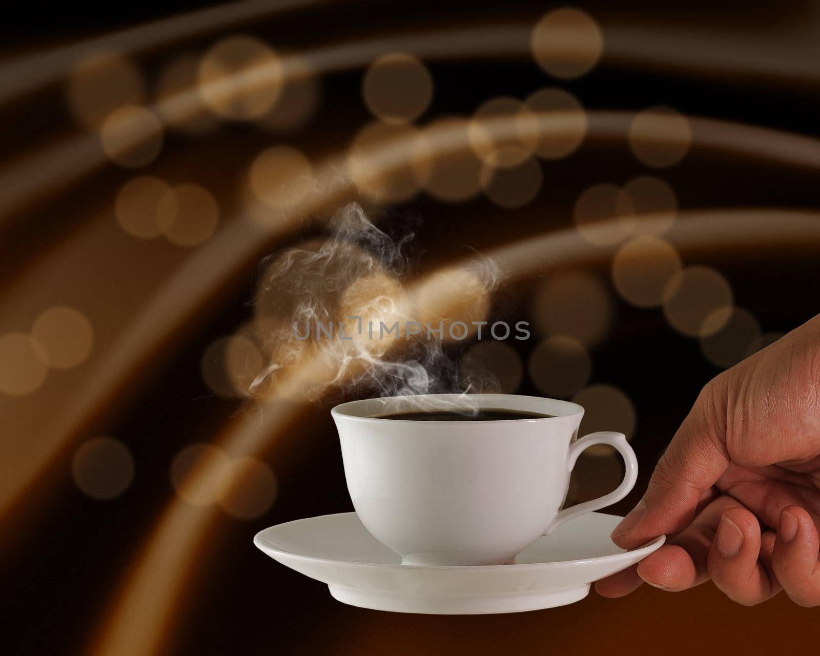 hand holds a cup of hot coffee