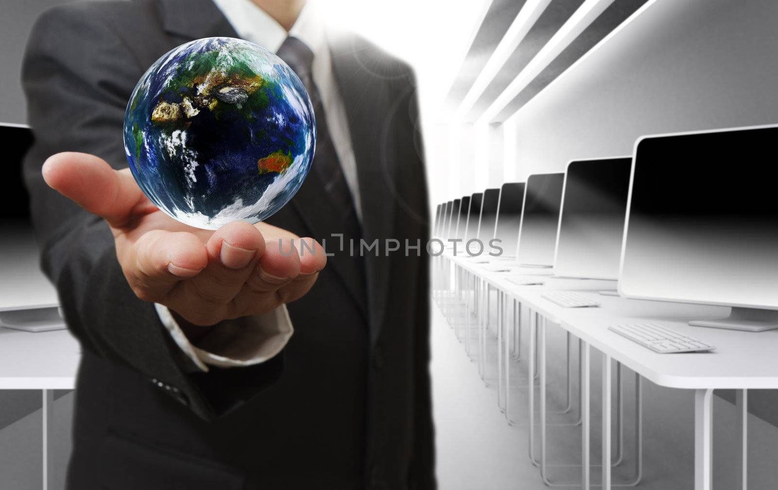 Business man hand holds globe by buchachon