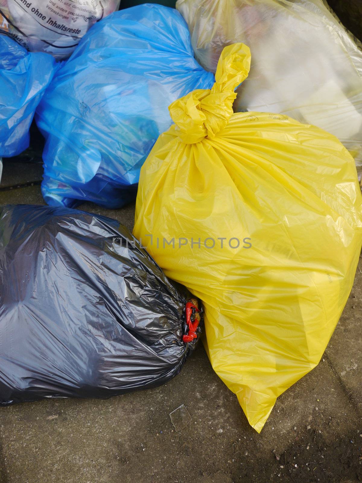 Many Garbage Plastic Bags With Different Colours Piled Up