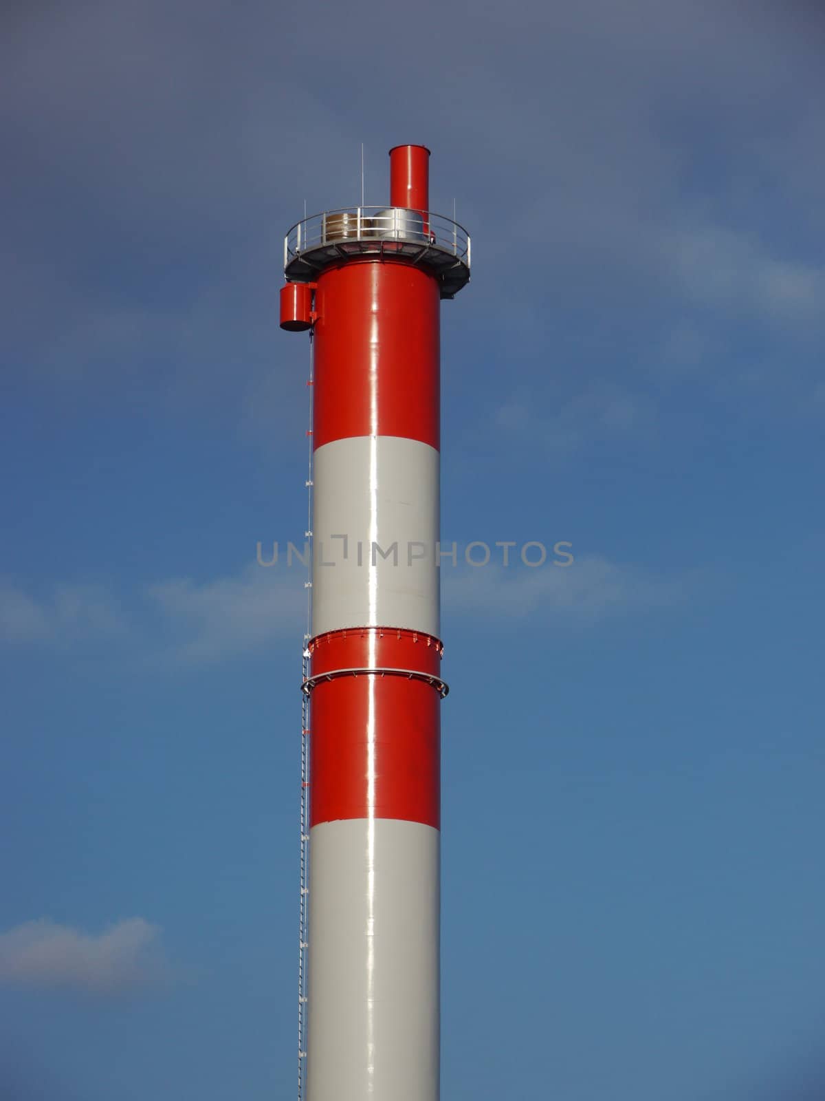red and white chimney against a blue sky