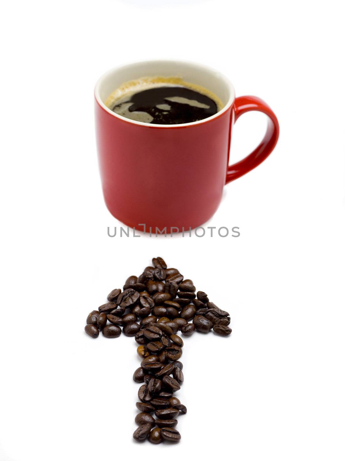 Coffee Beans placed into an arrow shape pointing towards a cup of coffee.