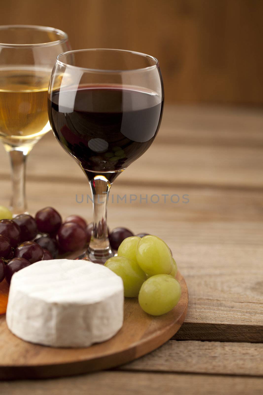 cropped image of grapes with feta cheese and wine glasses by kozzi