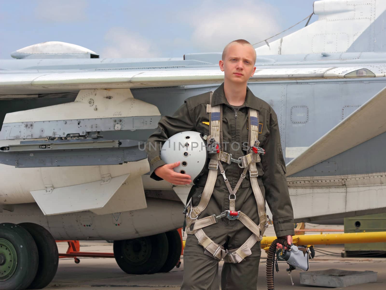 military pilot in a helmet near the aircraft