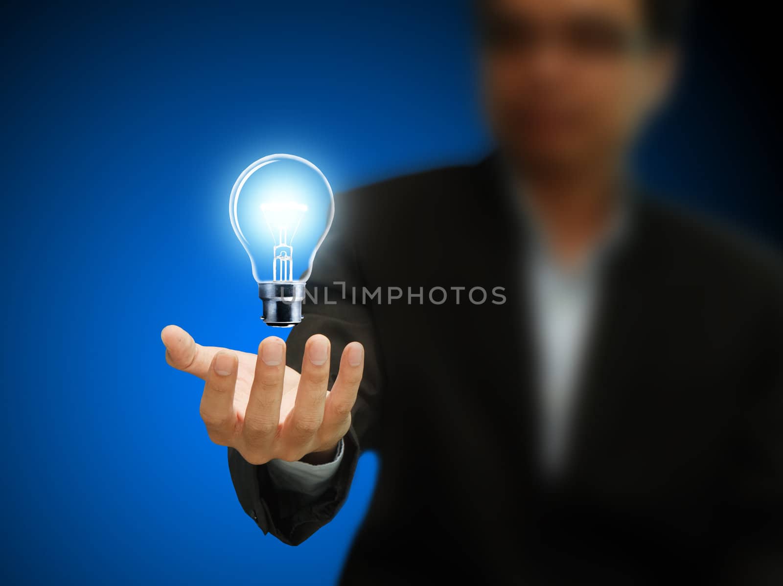 Businessman hand hold a light bulb
