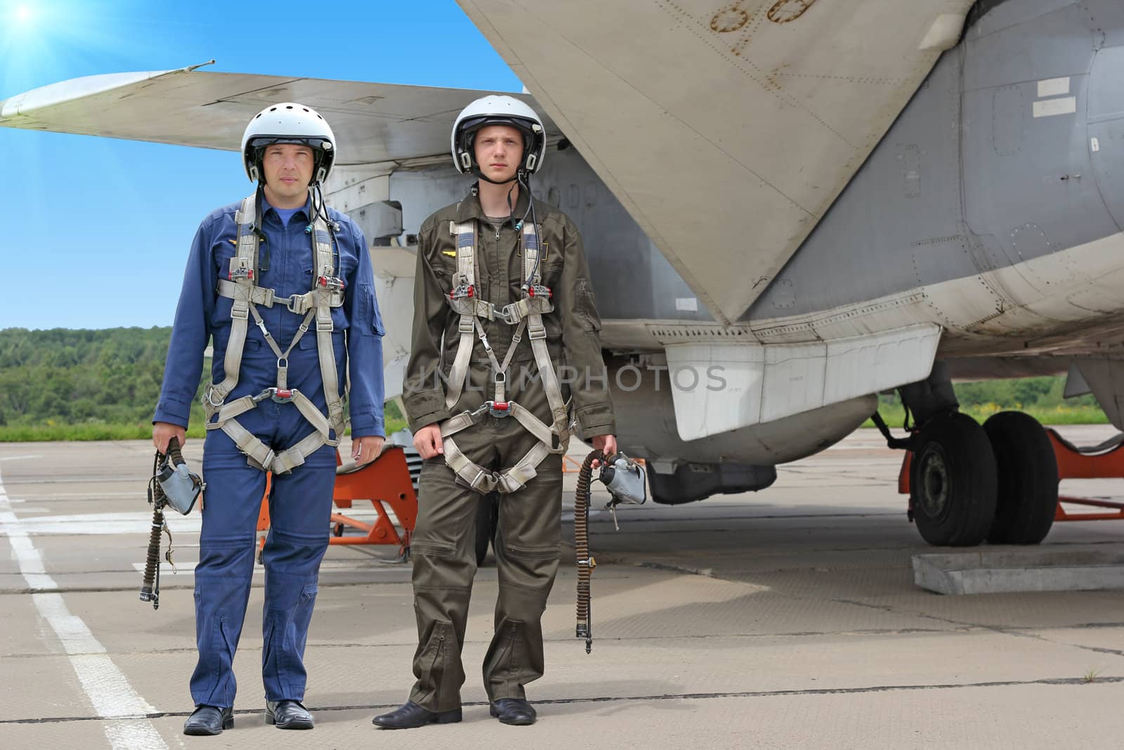 Two military pilot in a helmet near the aircraft