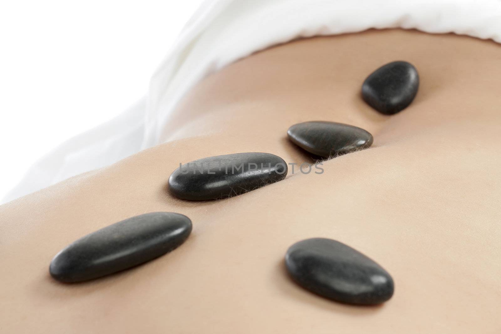 Close up image of female having stone massage