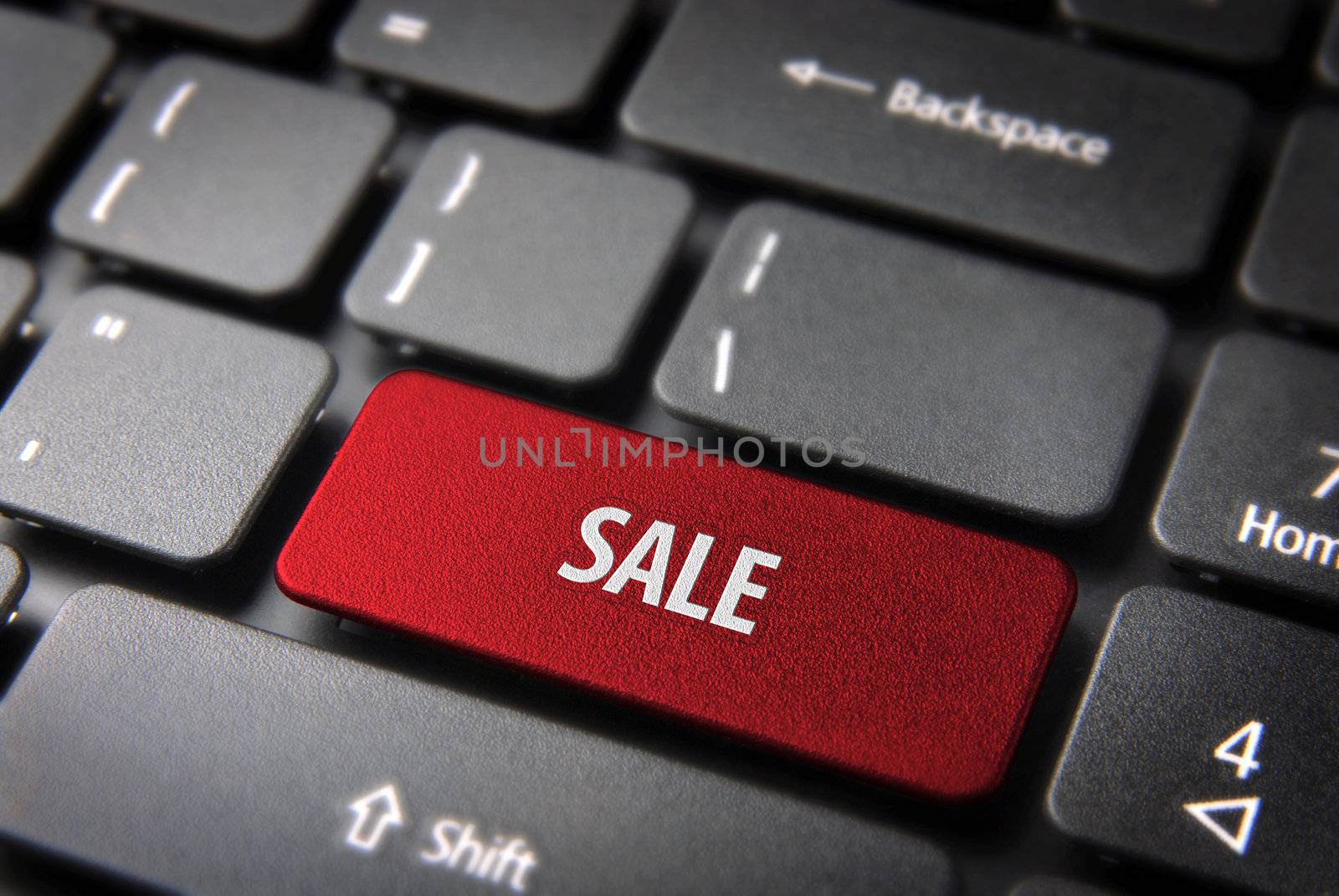 Online shopping season offer: red button with sale text on laptop keyboard. Included clipping path, so you can easily edit it.