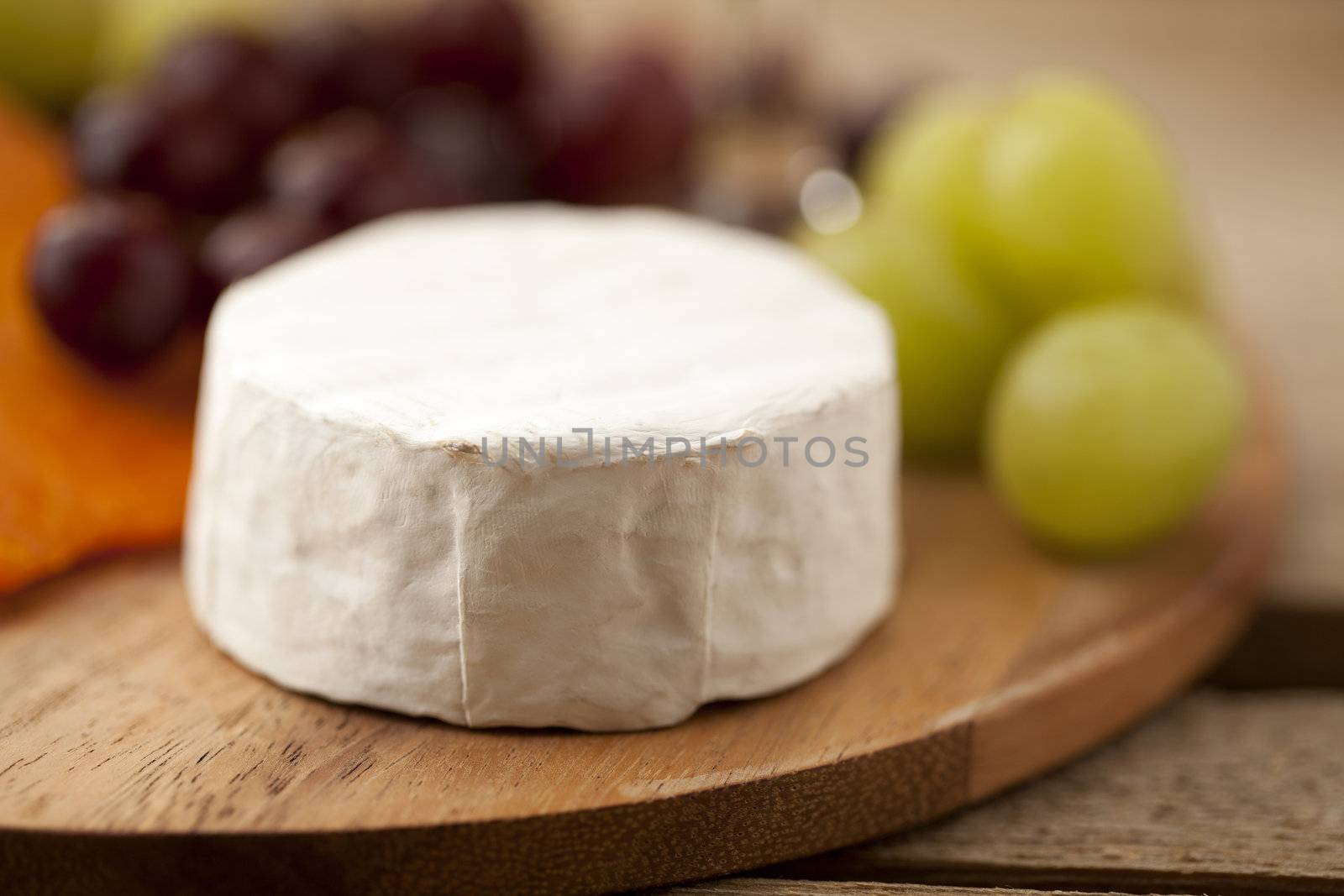 Feta cheese and grapes on a wooden board