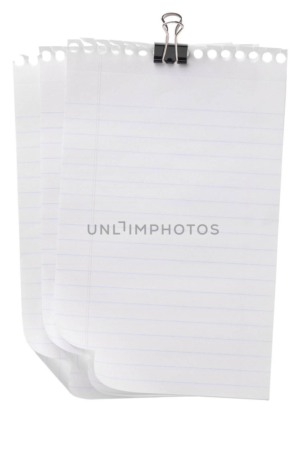 Few pieces of notebook paper with clip on a close up image