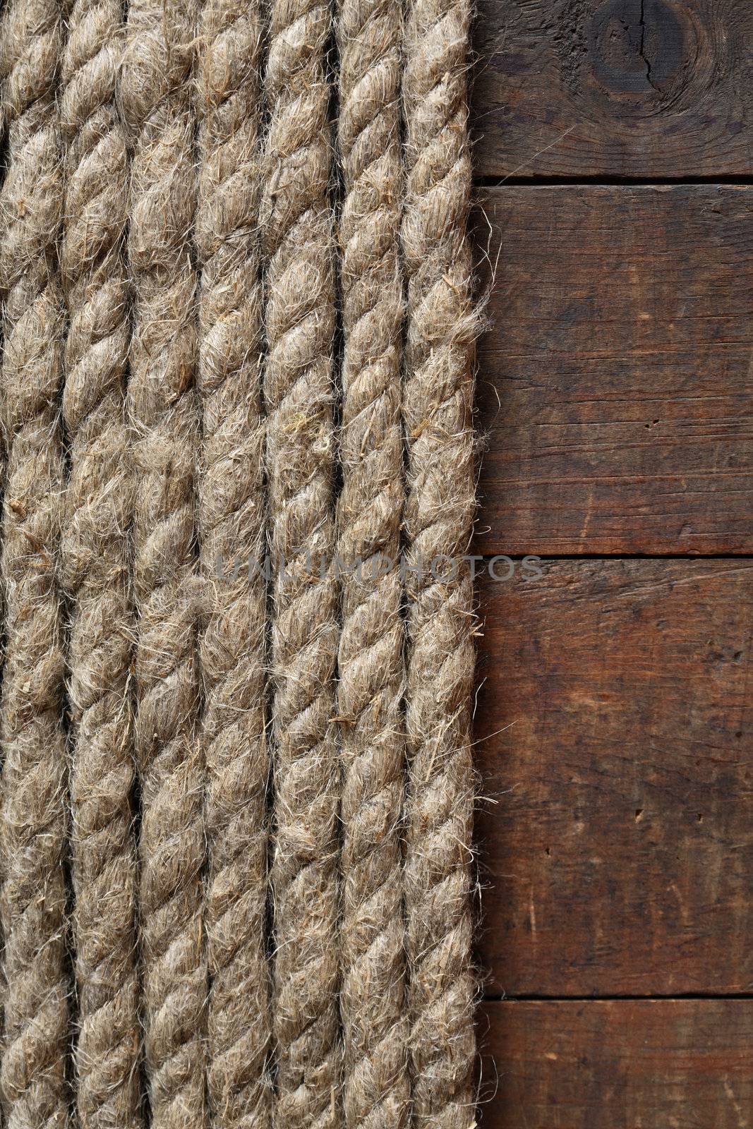 Old hemp rope on dark wooden surface