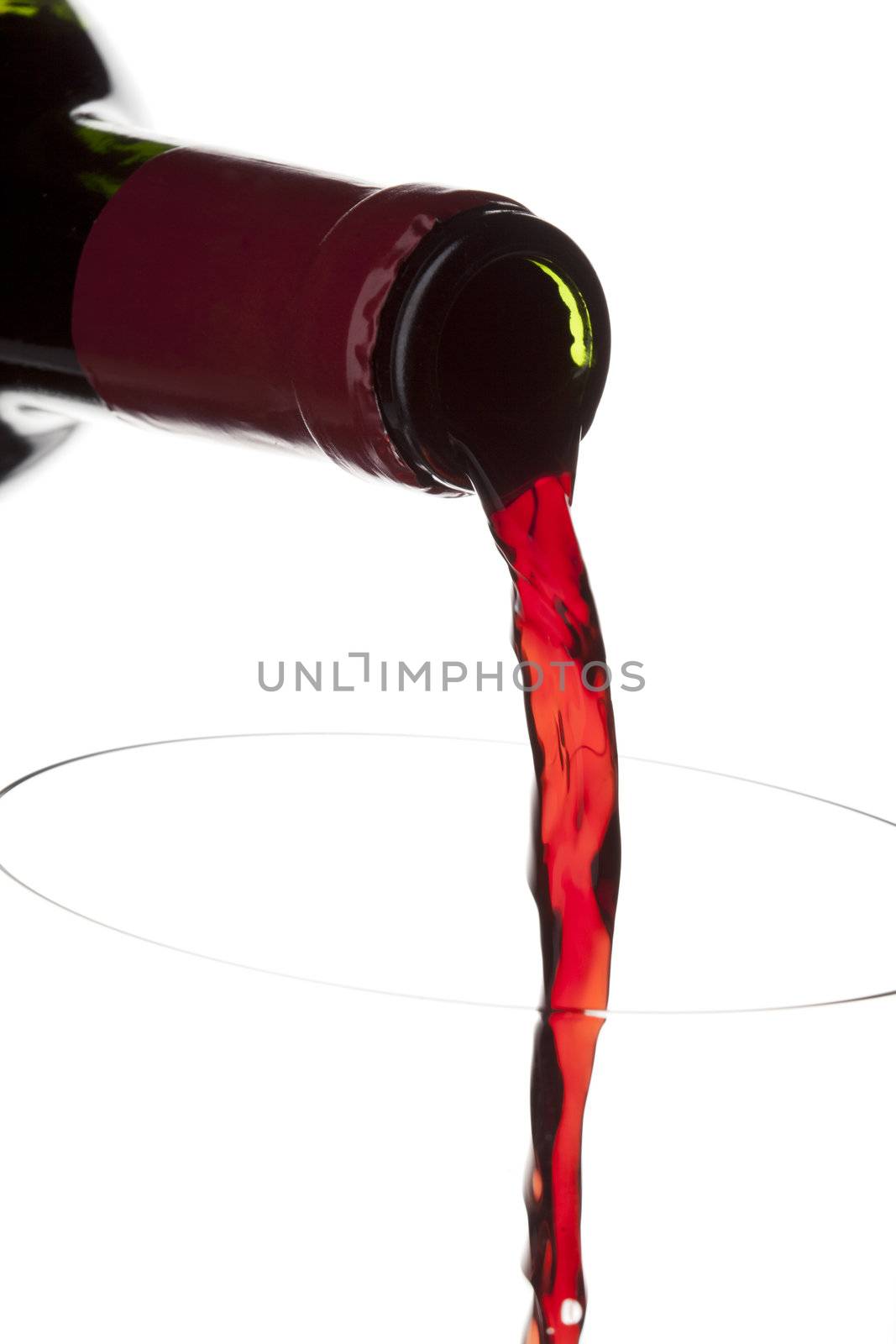 Flowing wine from a bottle displayed on white background.