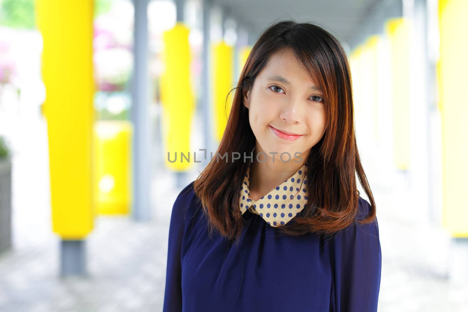 young woman smiling friendly on street