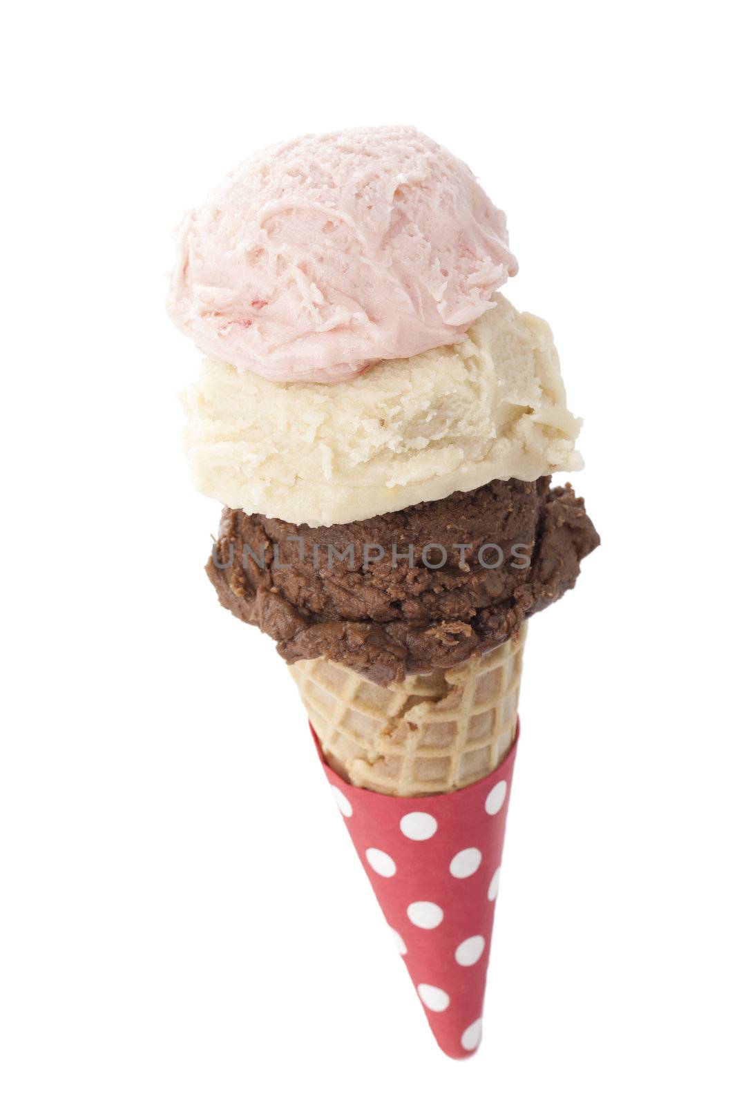 Three scoops of ice cream in a sugar cone over white background